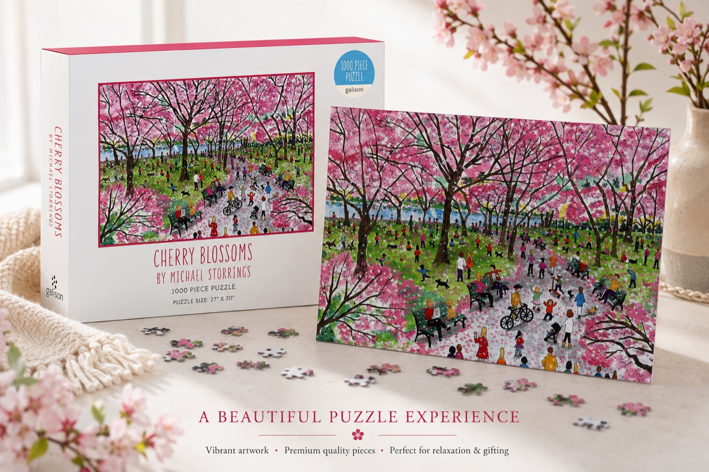 Galison Cherry Blossoms 1000-piece jigsaw puzzle box next to the assembled park scene artwork.